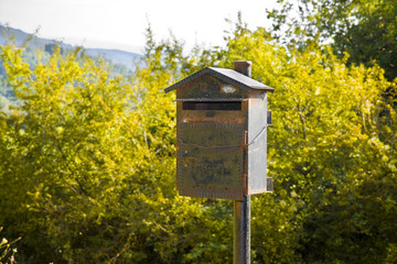 Old metal mailbox in the countryside. New ways of communication