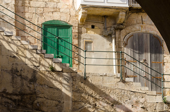 Old green fringed door in Valletta, Malta