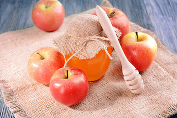 Delicious honey with apple on table close-up