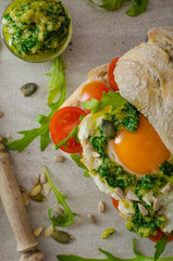 Ciabatta with fried egg, tomatoes and pesto