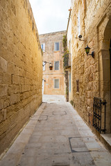 Fototapeta na wymiar Street in an old European town (Mdina, Malta)