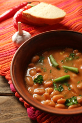Bean soup in bowl on wooden table background