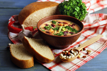 Bean soup in bowl with fresh sliced bread