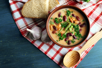 Bean soup in bowl with fresh sliced bread