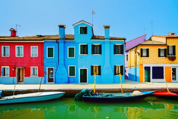 Fototapeta na wymiar Venice landmark, Burano island canal, colorful houses and boats,
