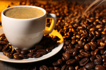 Cup of coffee with grains, closeup