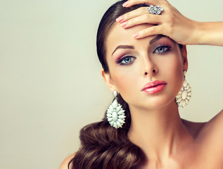 Girl fashion model with graceful earrings and ring