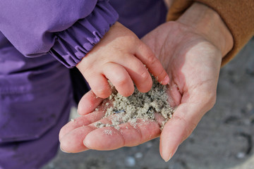 Baby hand with sand