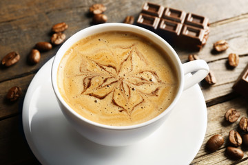 Cup of coffee latte art with grains and chocolate