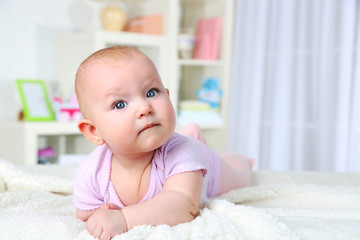 Cute baby girl, on home interior background