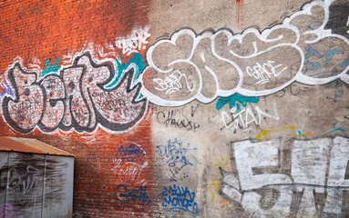 Poster Graffiti Mur de briques urbaines avec graffiti grungy