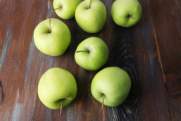 Green apples on wooden background