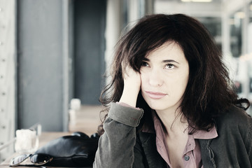 Portrait of the beautiful woman sitting in the cafe