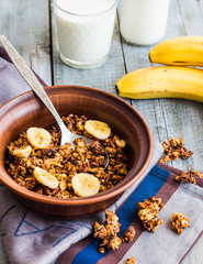 homemade granola with bananas, nuts and dates, milk