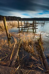 Lake with old destroyed pier