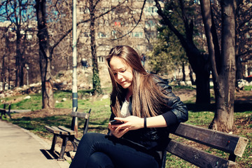 Fototapeta na wymiar Girl Texting On The Smart Phone