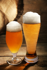 Glasses of beer on wooden background
