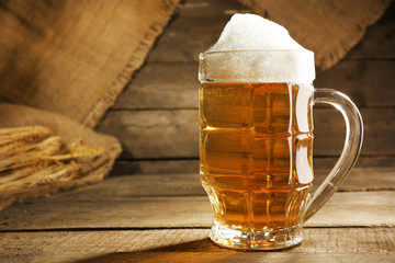 Glass of beer on wooden background