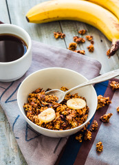 banana granola with nuts, figs and honey in a white piala