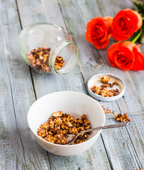 homemade granola with nuts and dried fruits, flowers
