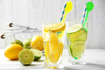 Cocktails with fresh citrus fruits on wooden background