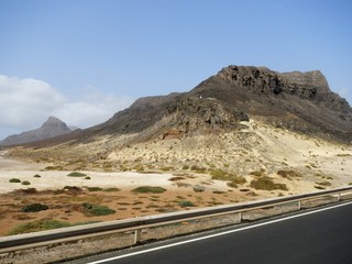 Tarmac road in desert with mountains