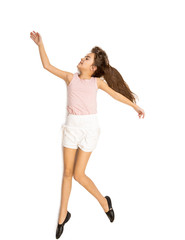 Isolated shot of cute girl dancing and jumping up high