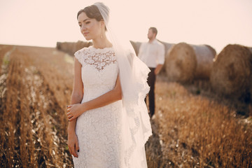 happy wedding couple in a field