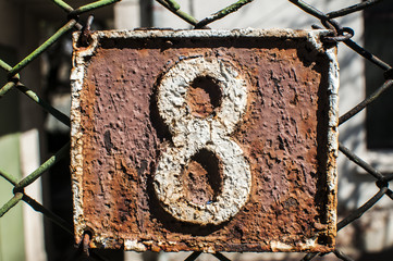 Old retro cast iron plate with number 8 on it