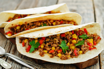 tacos with meat, corn and peppers