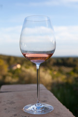 Glass of cold rose wine on a terrace with a stunning view