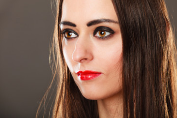 Fototapeta premium woman long straight hair dark makeup red lips on gray