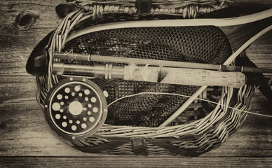 Creel filled with antique trout fishing equipment - obrazy, fototapety, plakaty
