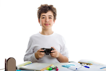 Boy playing with console controller and homework