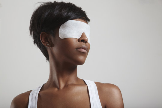 woman with a white cosmetic eye mask