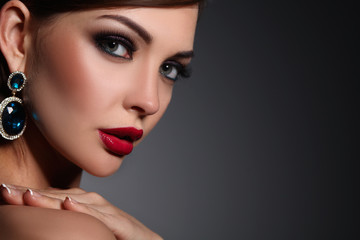Portrait of beautiful young brunette woman in ear-rings
