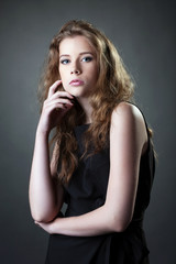 Naklejka premium Beautiful girl posing in black casual dress