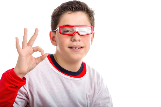 Caucasian smooth-skinned boy wearing red goggles makes OK sign