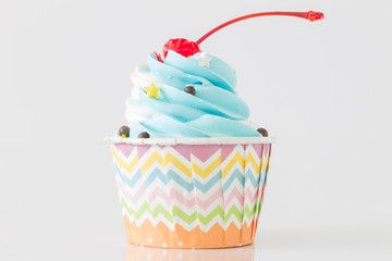 Colorful Cupcakes with icing and chocolate on white background