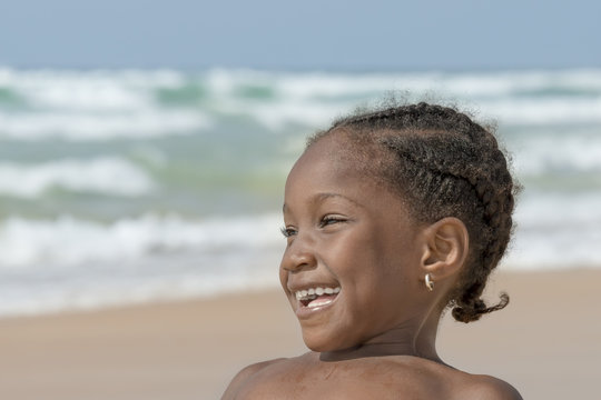 Happy girl at the beach, six years old