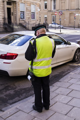Policeman giving a ticket to a bad parked car