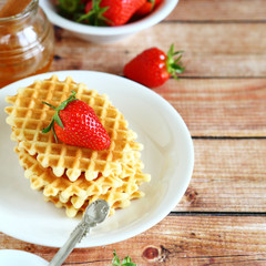Waffles with fresh strawberries on a plate