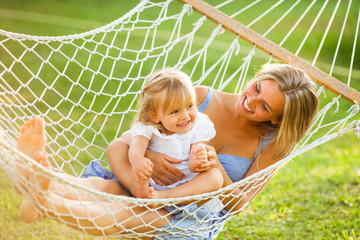 Happy mother and daughter in hammock