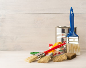 paint bucket and paintbrush  on wood