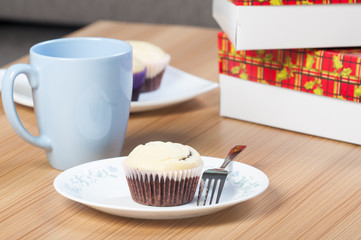 a chocolate cupcake with cream cheese on top