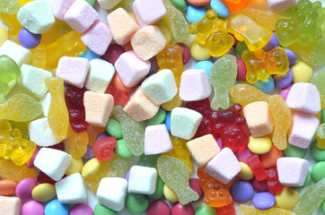 Candy, colored smarties and gummy bears background