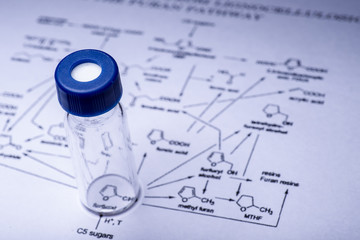 Sample vial on the paper of chemical formula