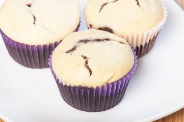 a chocolate cupcake with cream cheese on top