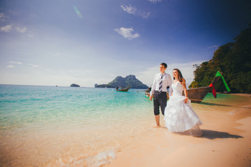 Fototapeta na wymiar bride and groom walk hand in hand