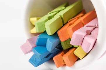 Group colorful pastel of wooden clothespins in coffee cup  isola